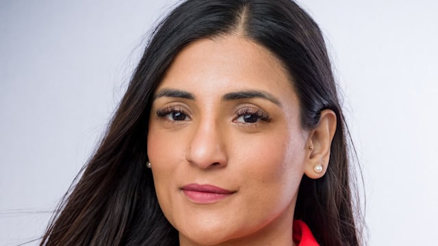 woman in a red blazer with long brown hair