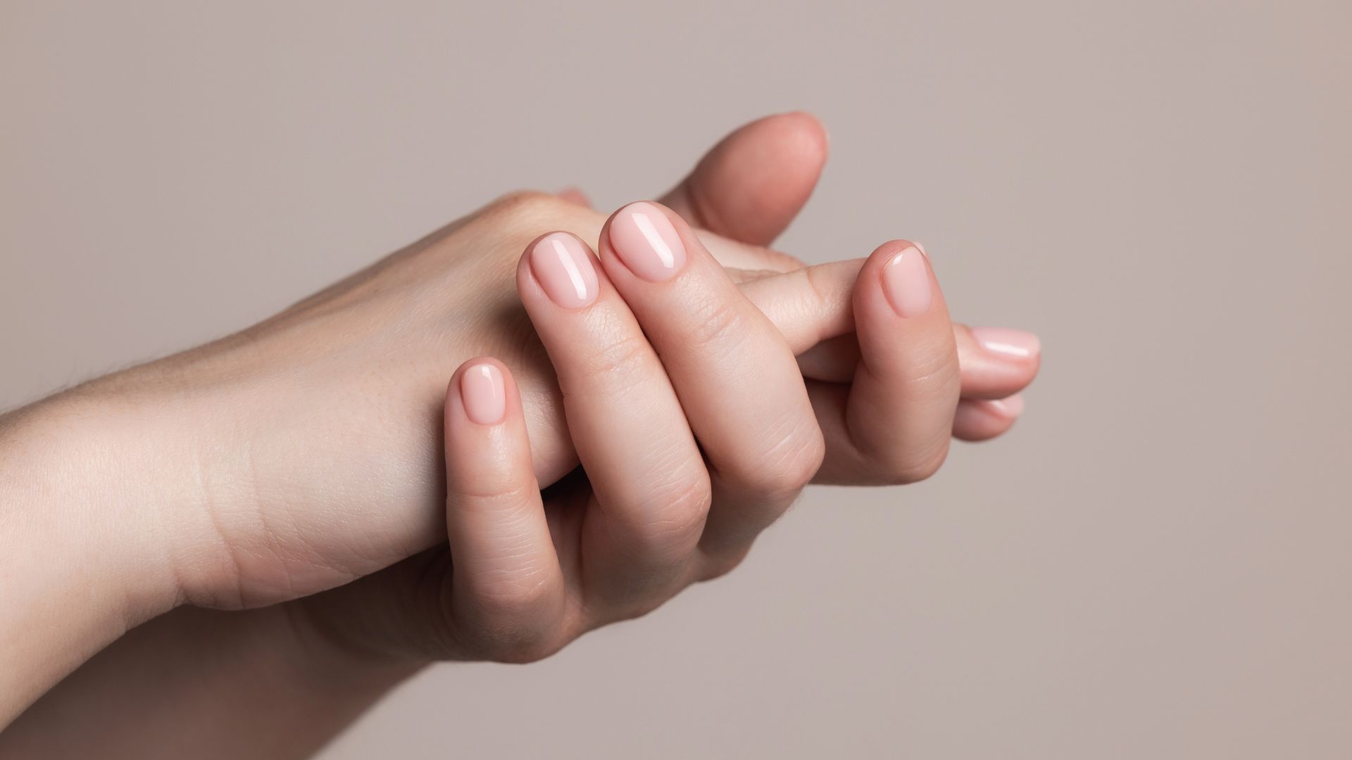 Hands with beautiful manicure - pink gel nails