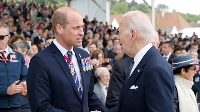 Britain's Prince William, the Prince of Wales (L) shakes hand with US President Joe Biden