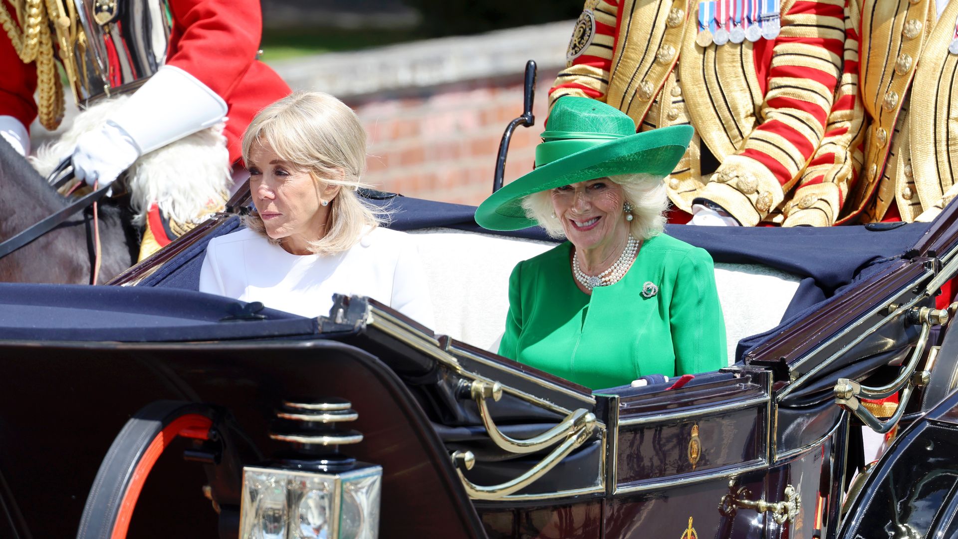 Brigitte Macron riding alongside Queen Camilla in a carriage