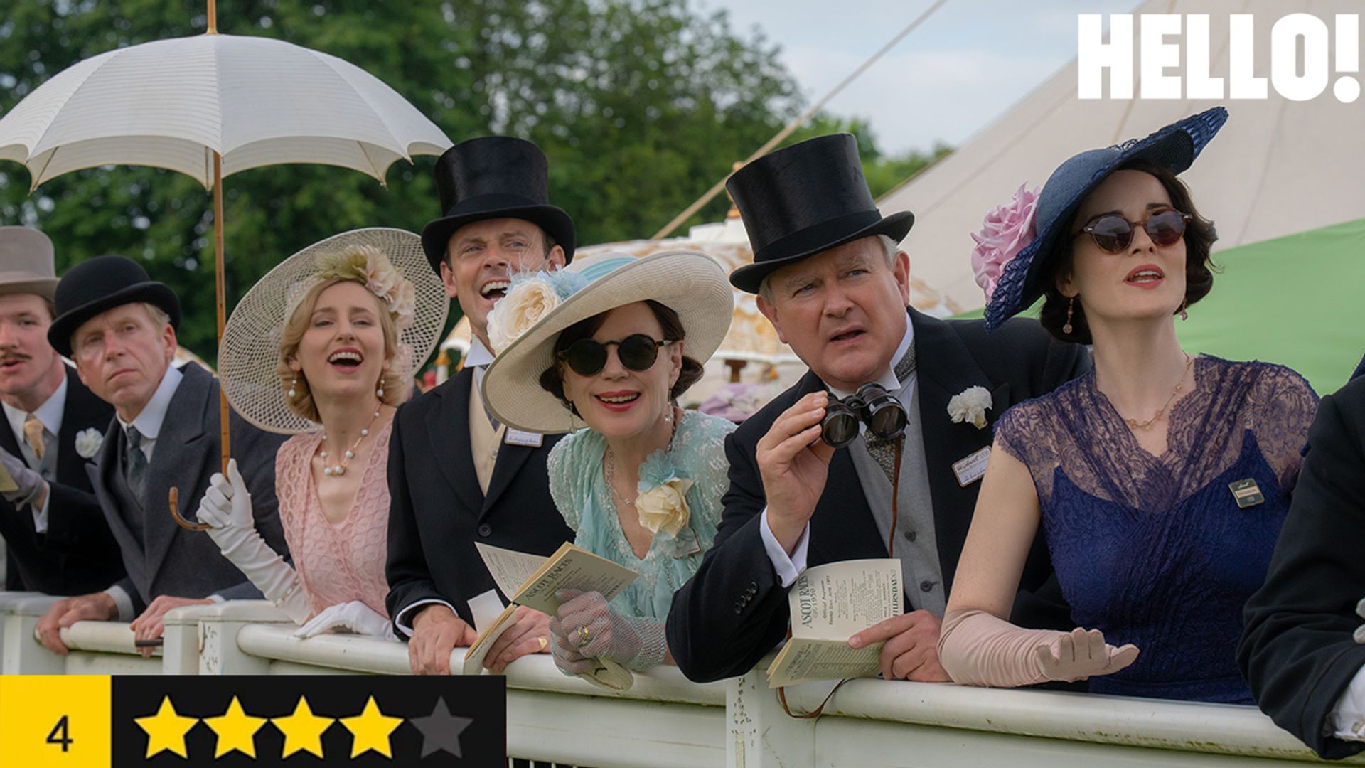 group of people watching horse racing behind barrier