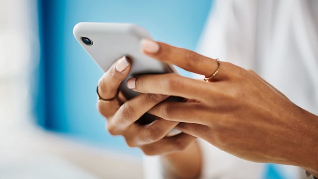 Studio shot of an woman checking her phone