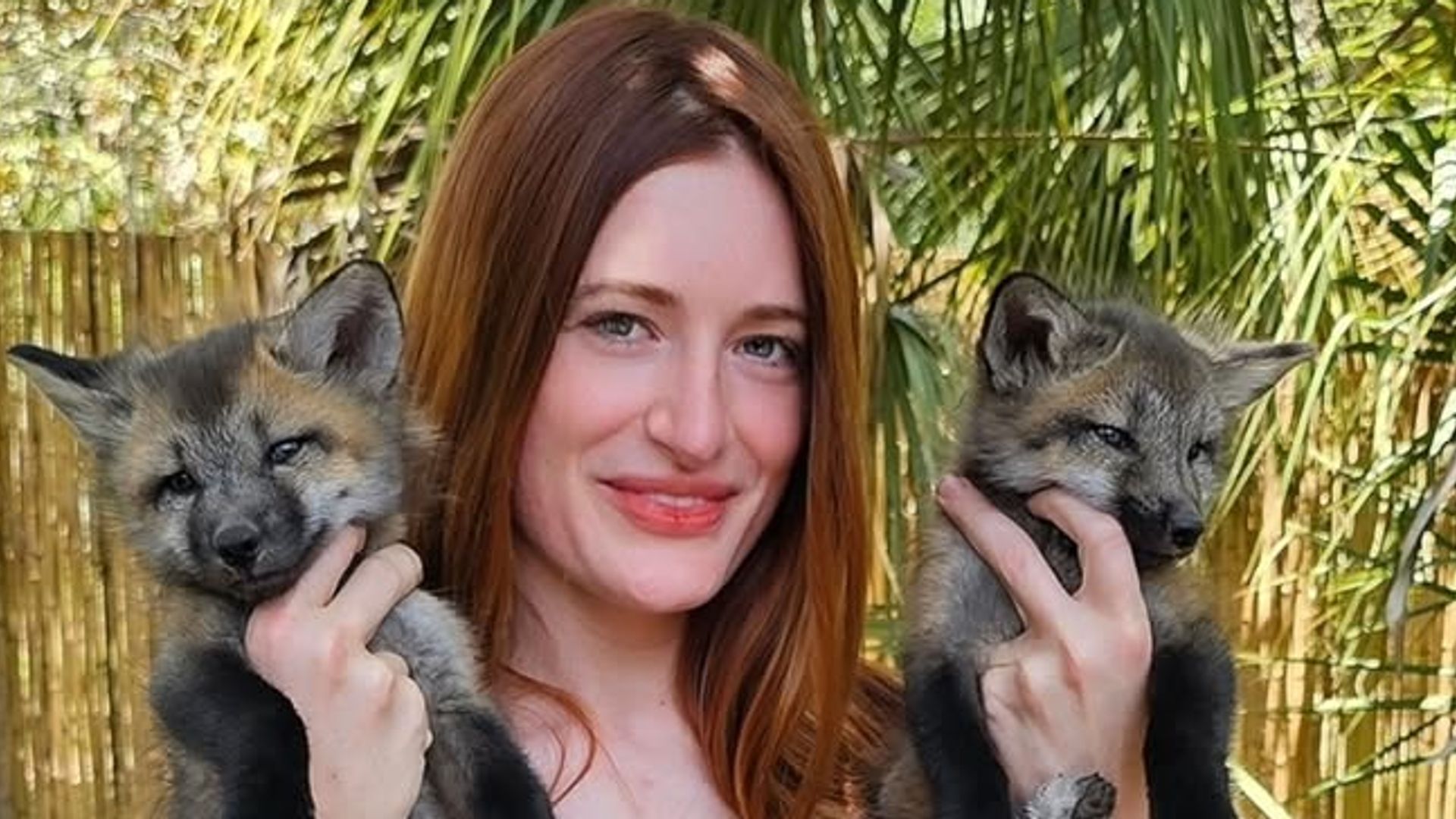 Mikayla Raines cuddles two foxes