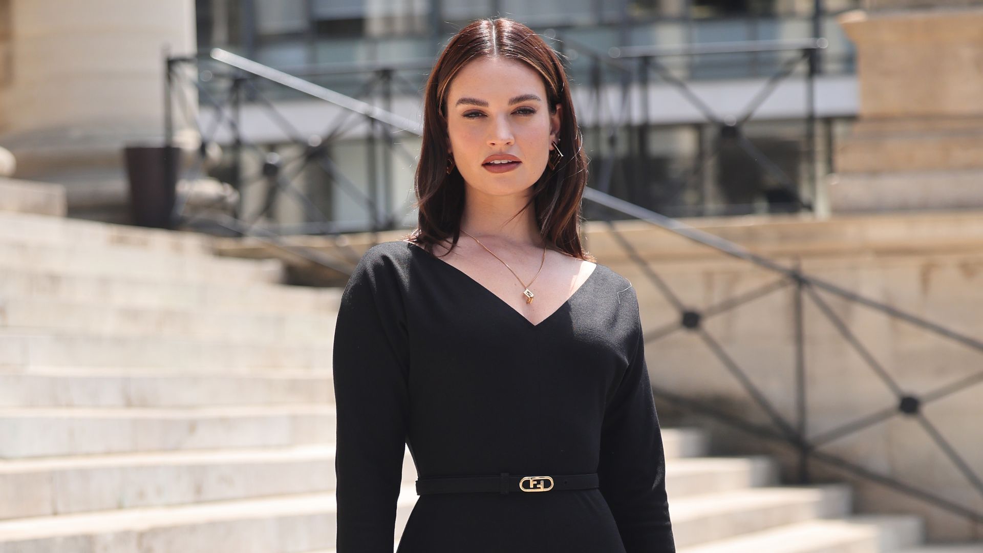 lily james in a black dress and heels