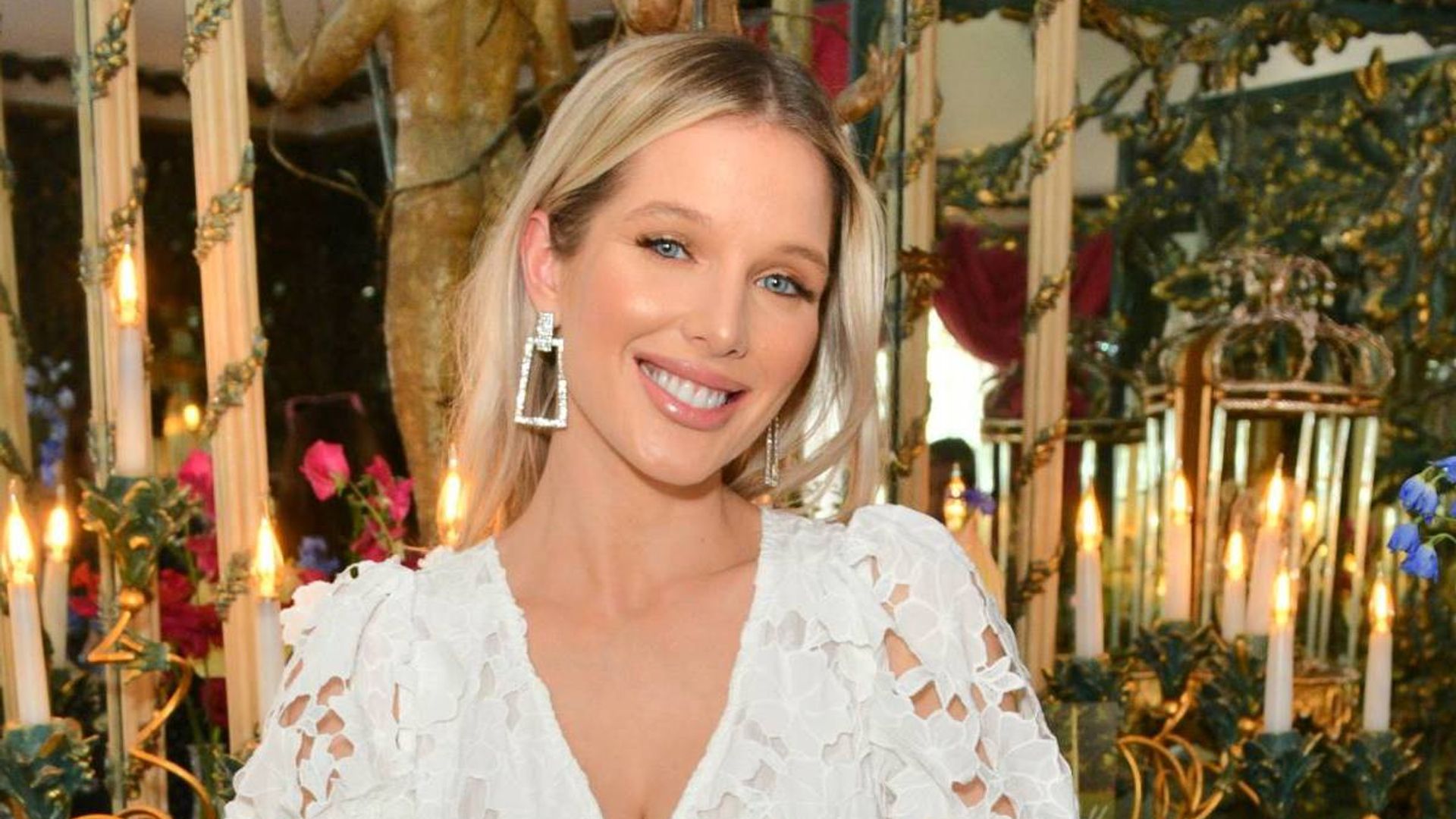 Helen Flanagan wearing a white lace dress and smiling at the camera
