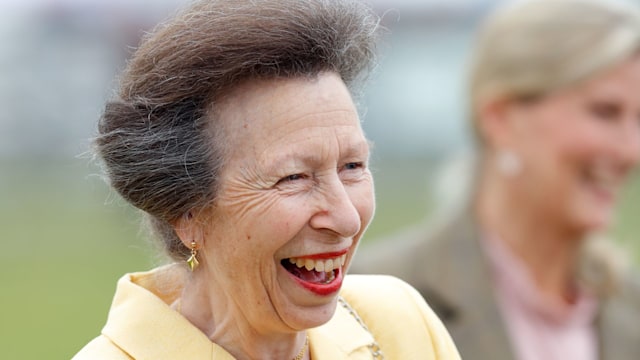 Princess Anne laughing in a yellow jacket