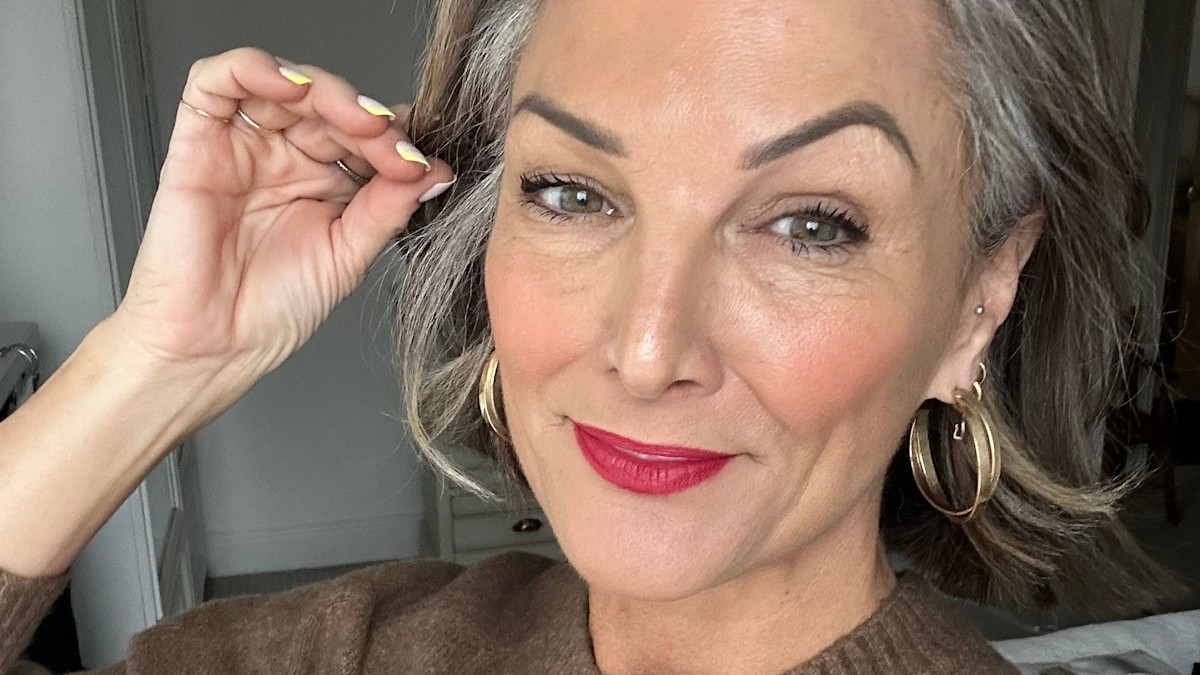 Woman with grey hair wearing flattering soft makeup