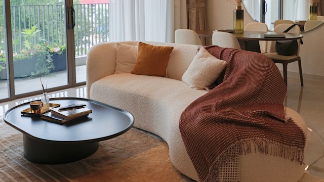 Modern Cozy Living Room with Curved Sofa and Warm Natural Light