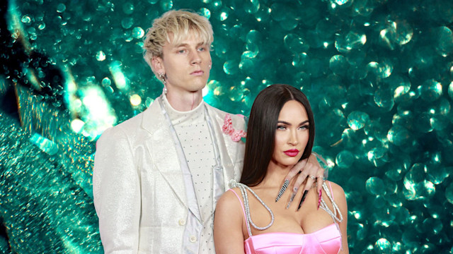 Megan Fox and Machine Gun Kelly with green glitter backdrop