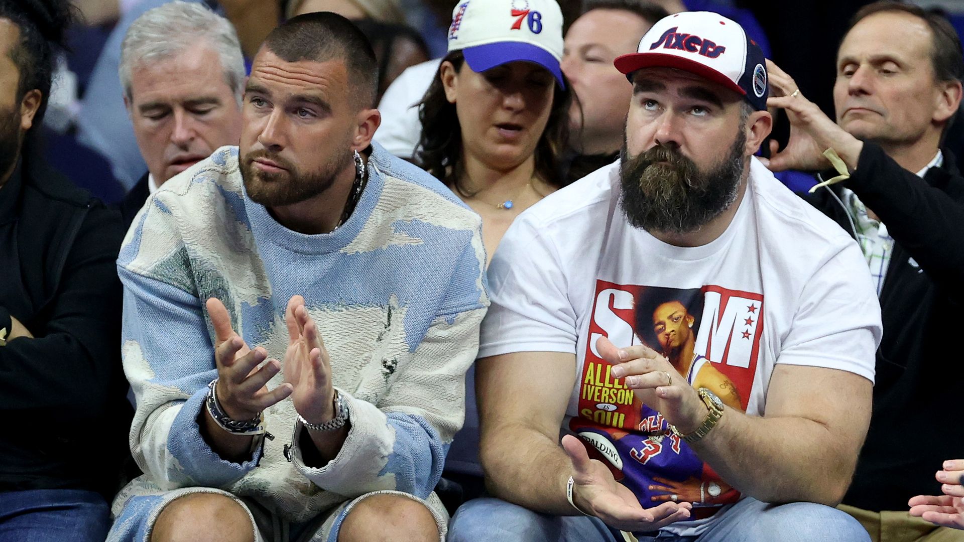 Travis Kelce of the Kansas City Chiefs and Jason Kelce of the Philadelphia Eagles watch game six of the Eastern Conference Semifinals in the 2023 NBA Playoffs 