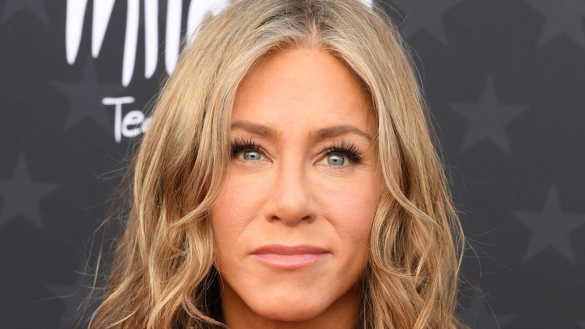 Jennifer Aniston defies expectations in caped look after hair