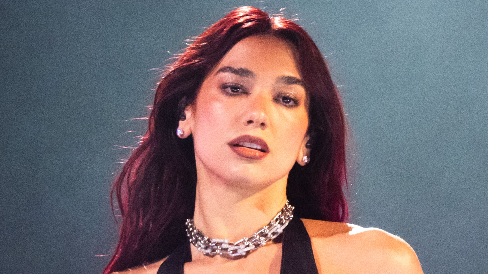 Dua on stage in a leather dress with chains