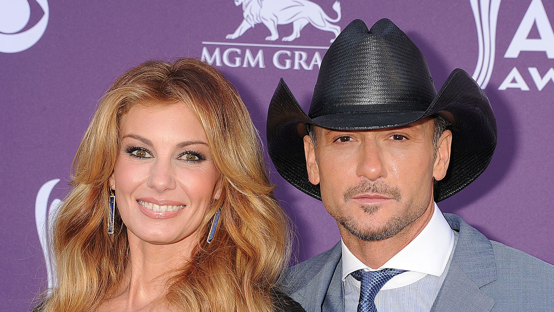 Faith and Tim together red carpet, with Tim wearing a cowboy hat