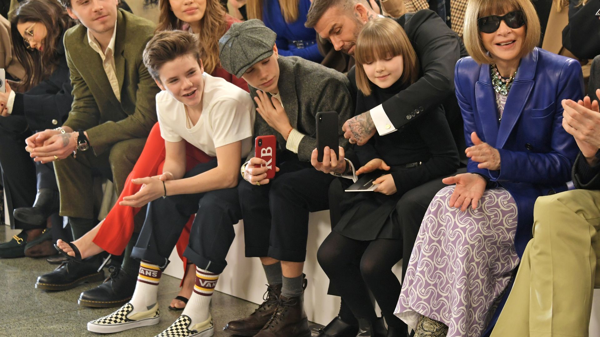 family sat in front row at fashion show