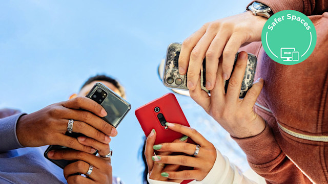 Three young people using mobile phones outdoors. 