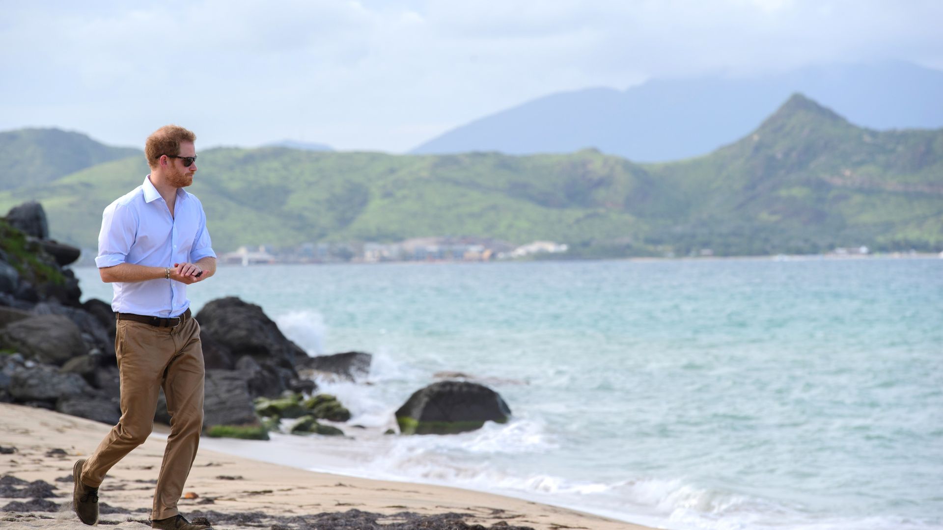 prince harry walking along beach