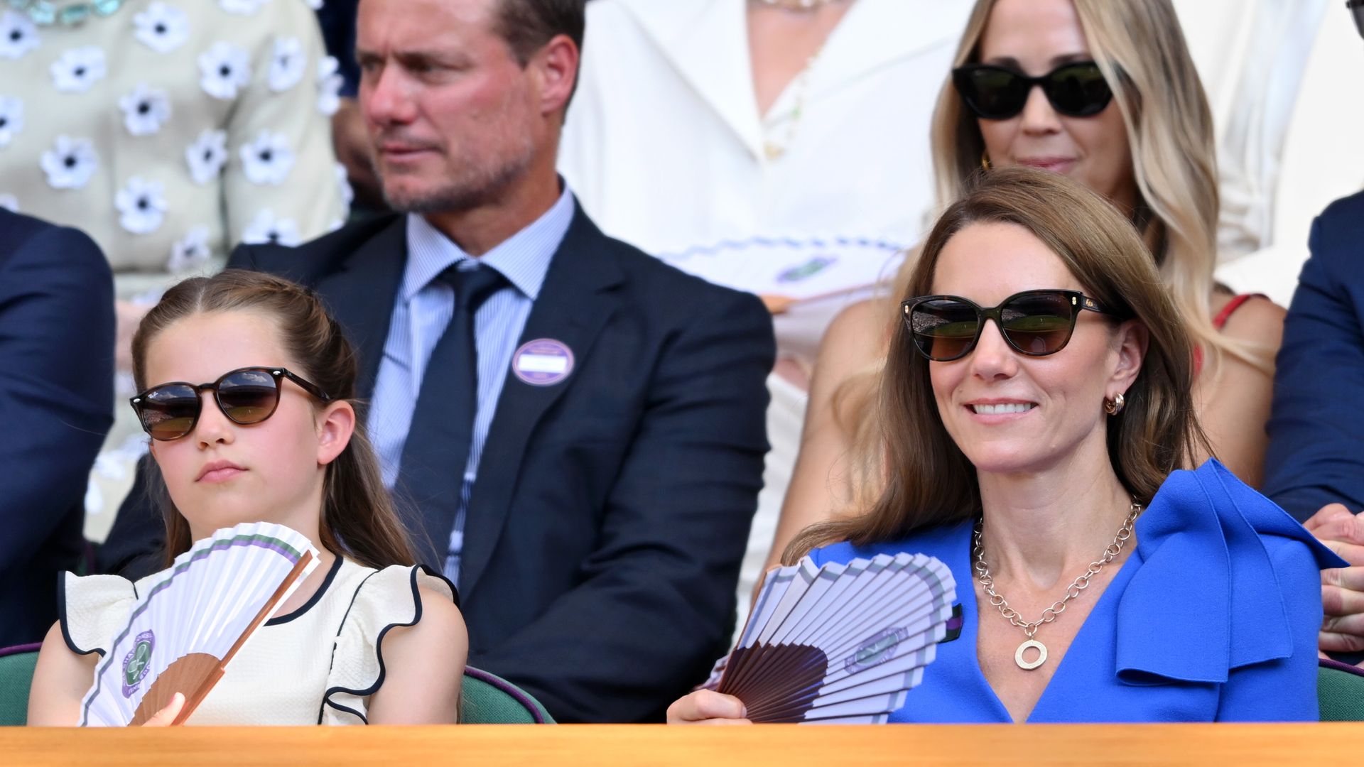 Kate and Charlotte waving fans