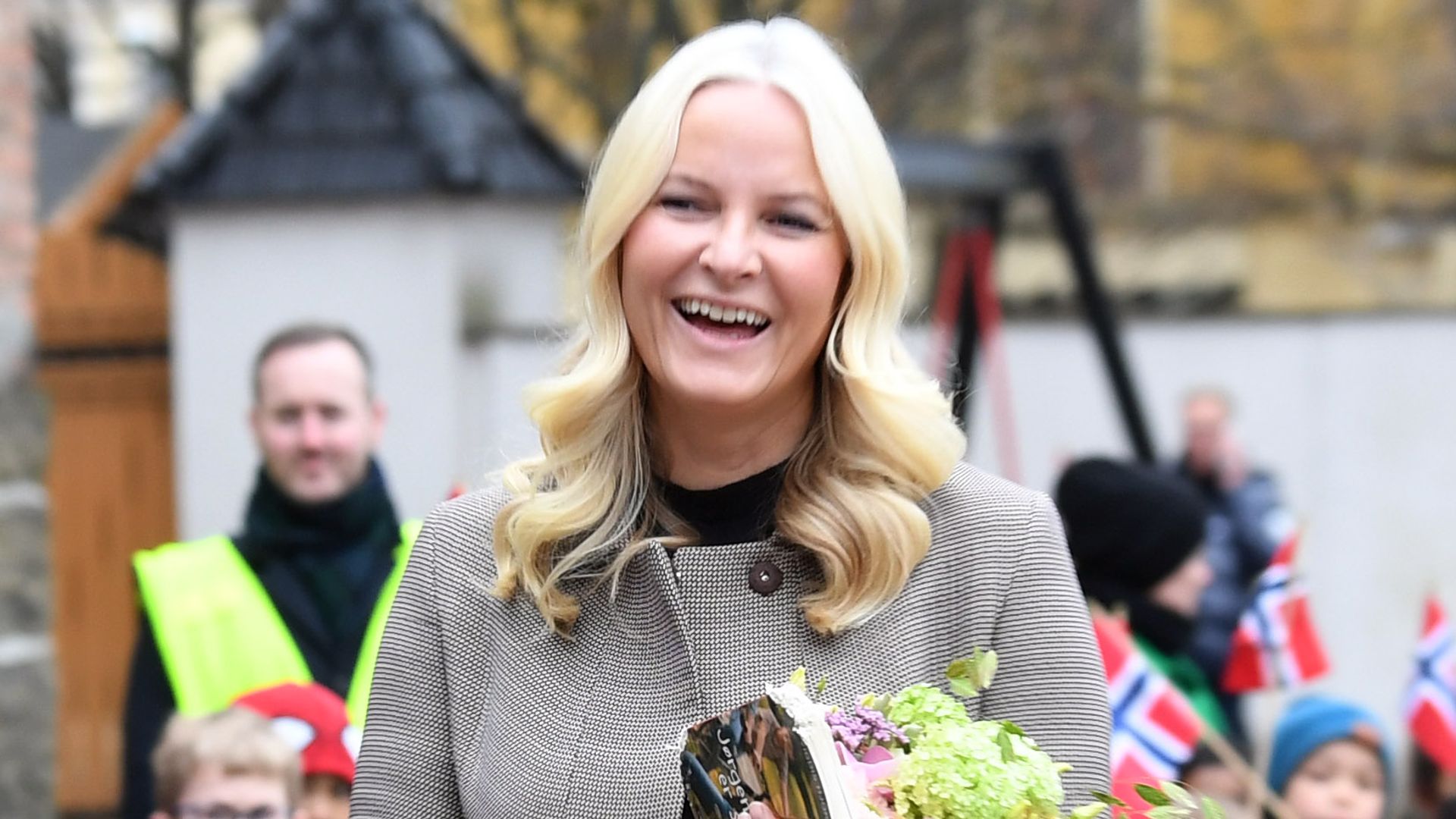 Crown Princess Mette-Marit of Norway smiling in front of crowds of wellwishers