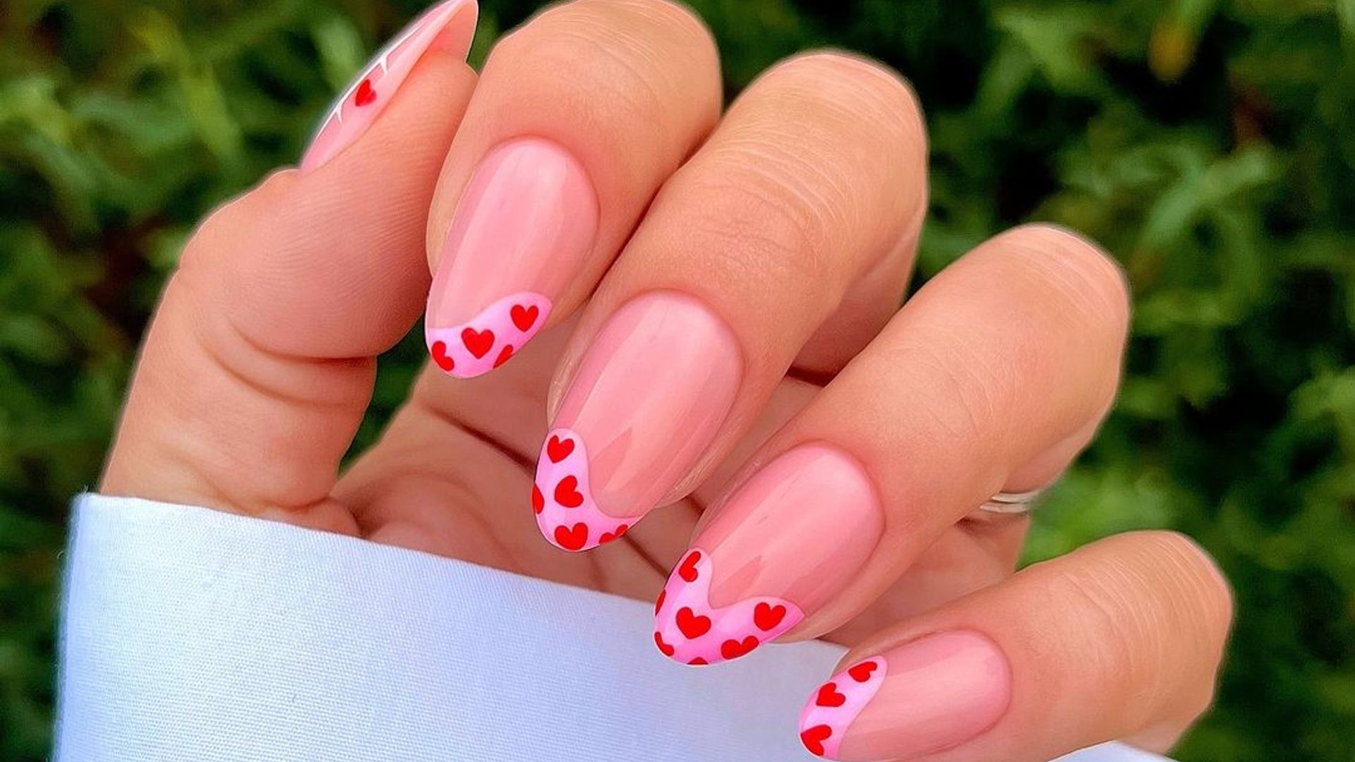 Nails with pink tips and red hearts 