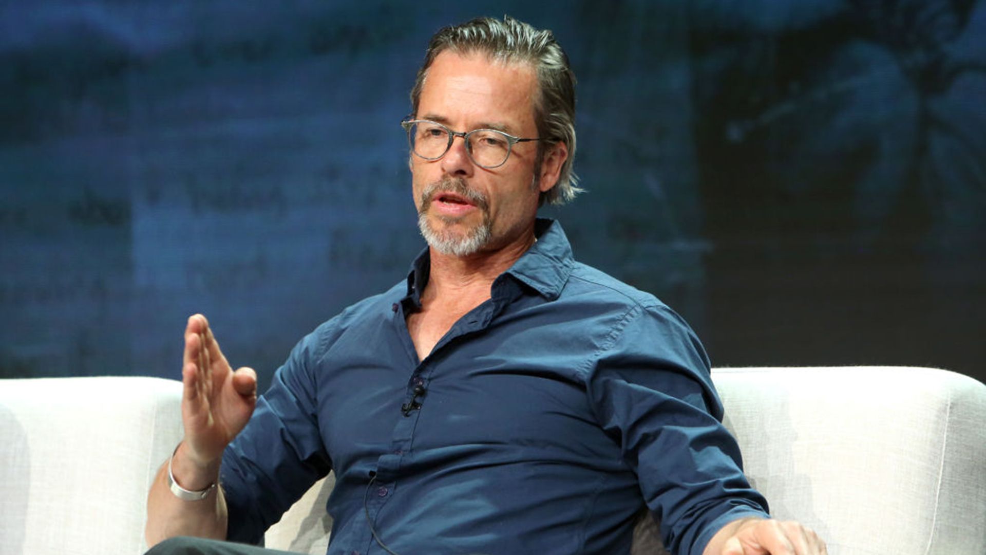 Guy Pearce talking on a TV panel in 2018