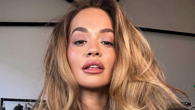 Rita Ora poses on her Instagram in a white tank top