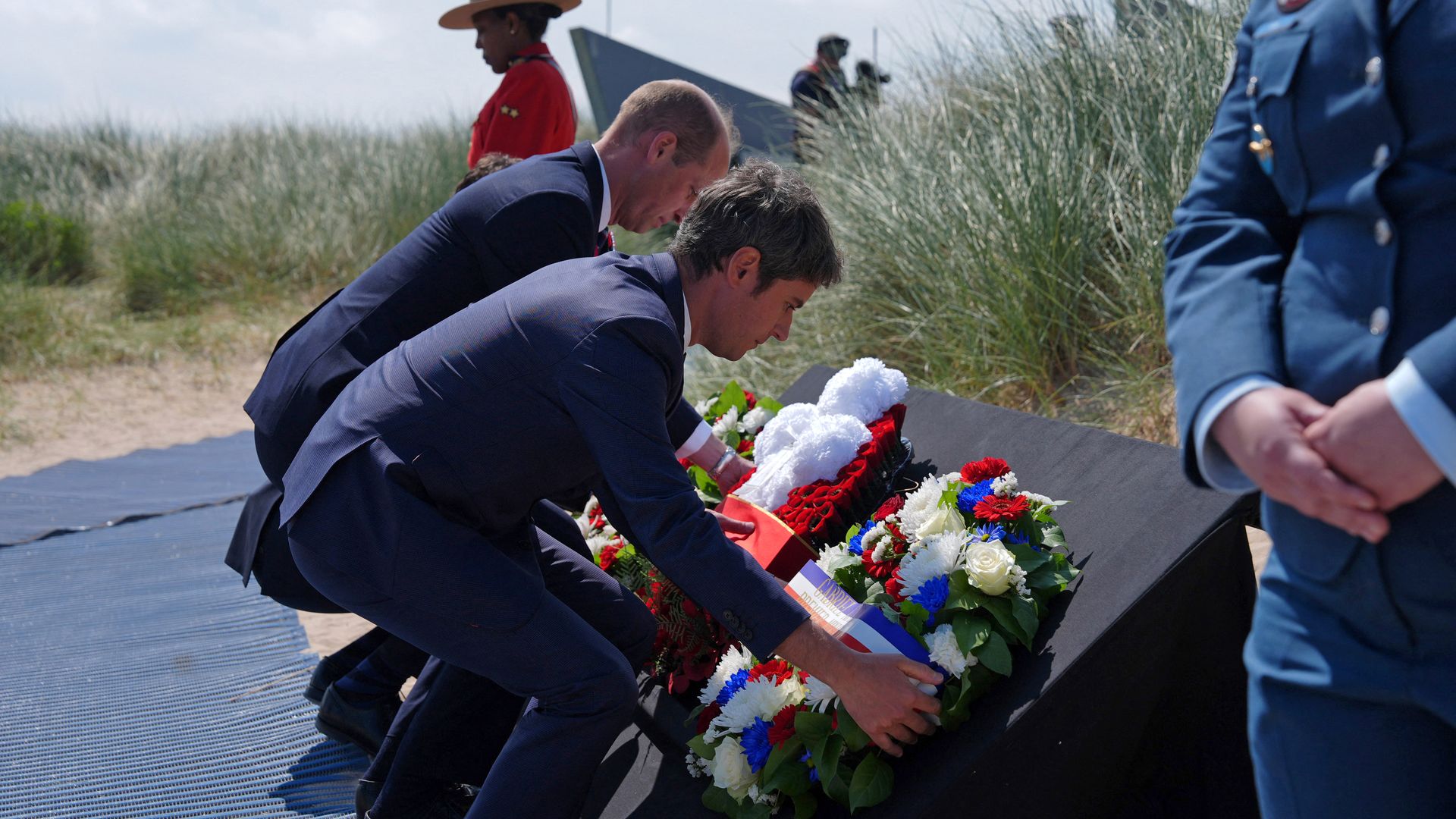men laying wreaths during ceremony 