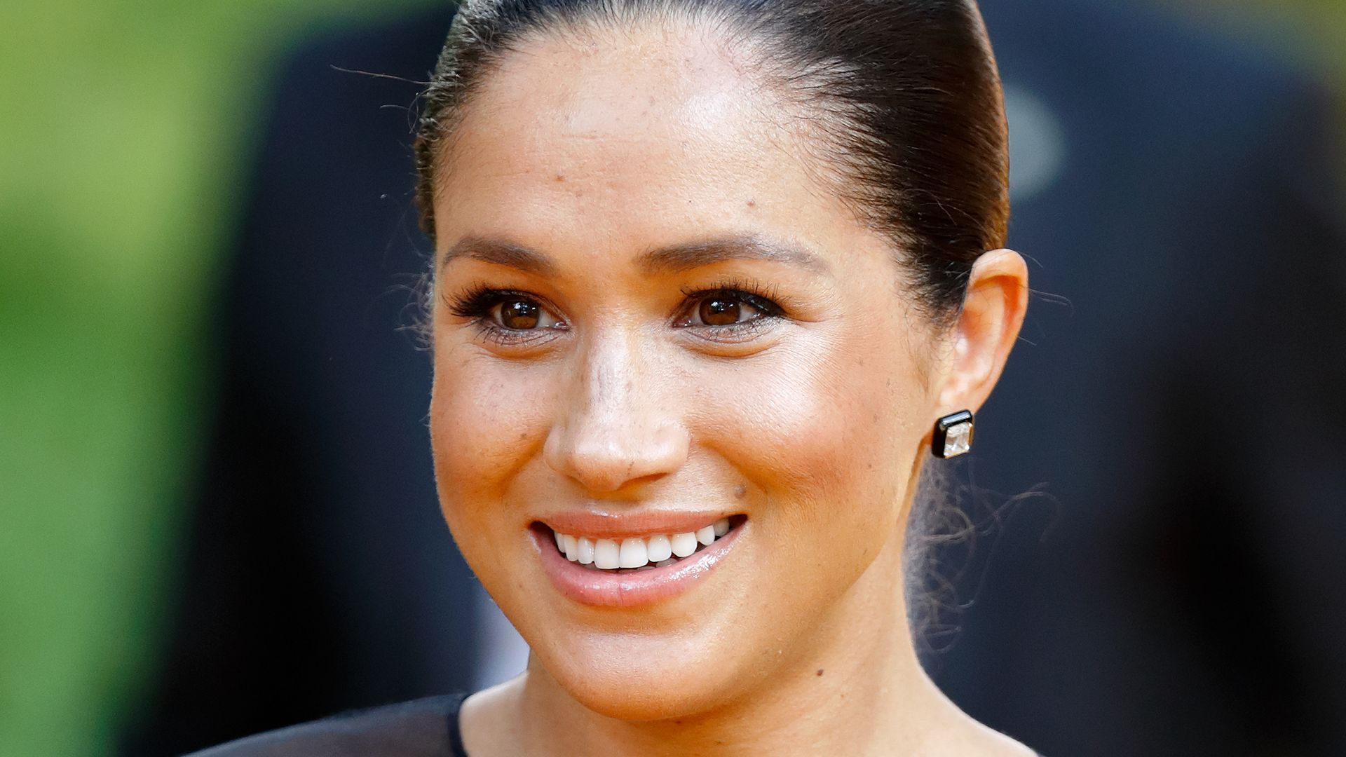 Meghan smiling in black dress close up