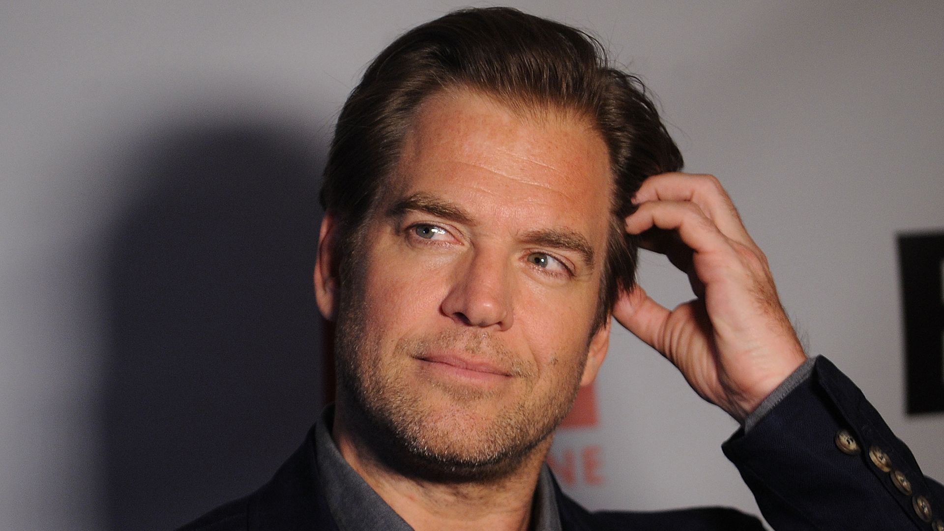 Michael Weatherly wearing a black suit. 