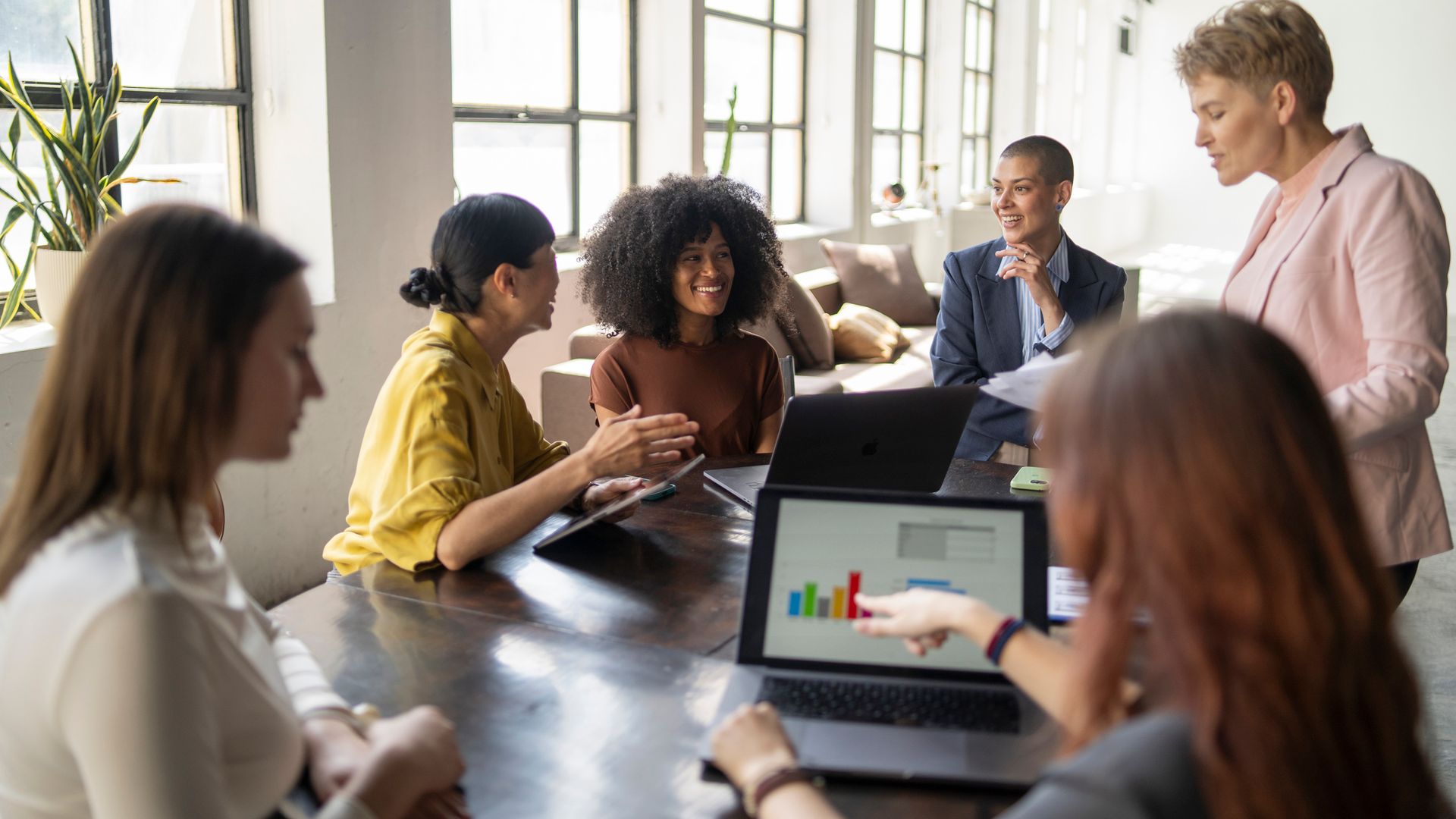 Businesswomen having a meeting discussing charts on a laptop