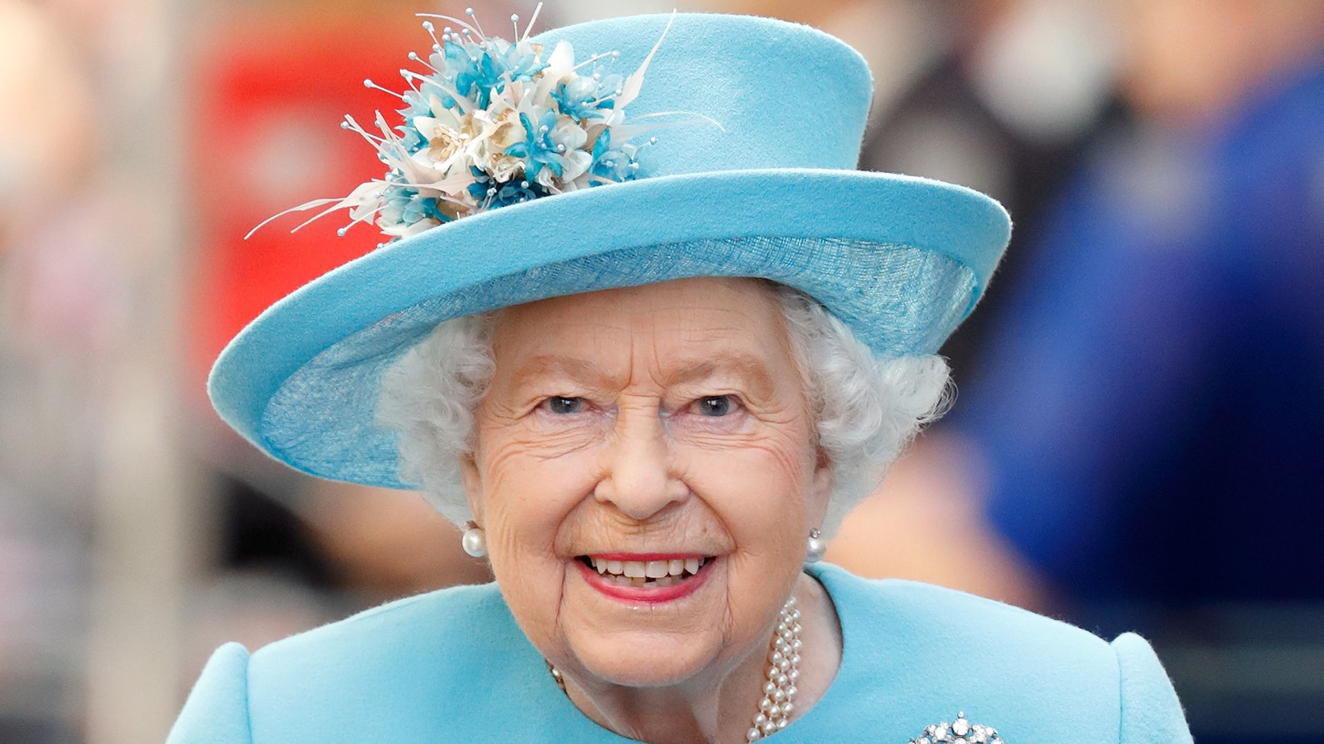 Queen Elizabeth II wearing a blue coat dress 