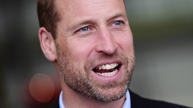 prince william smiling in blue shirt and suit 