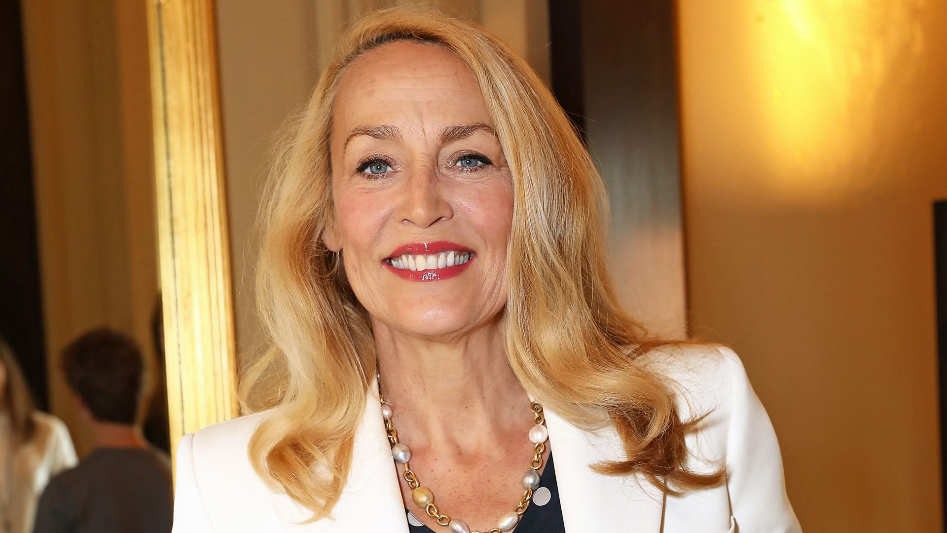 Jerry Hall smiling for the camera in a full length photo