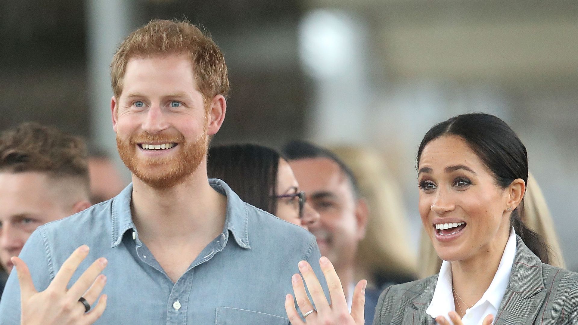 Prince Harry, Duke of Sussex and Meghan talking with hands held out