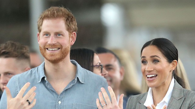Prince Harry, Duke of Sussex and Meghan talking with hands held out