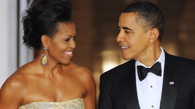 Michelle Obama in a strapless wedding dress with Barack Obama in a suit