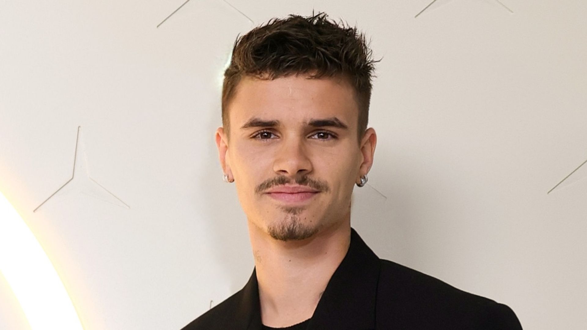 Romeo Beckham in a black outfit