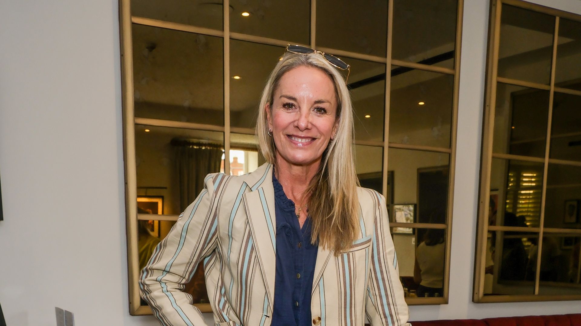 Tamzin Outhwaite  in jeans and a blazer smiling happily 