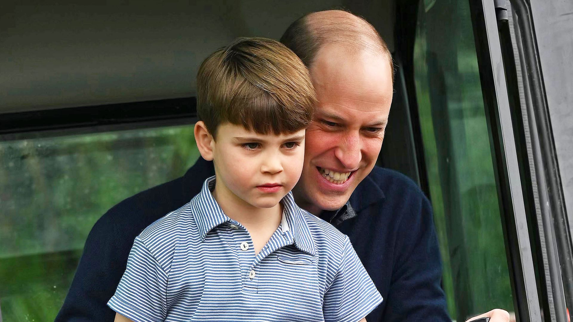 Prince Louis with sitting on Prince William in tractor
