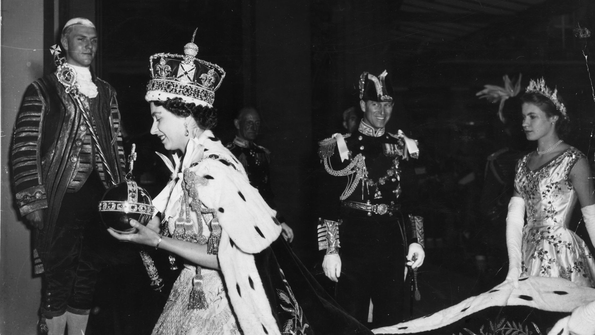 2nd June 1953:  Queen Elizabeth II, wearing the Imperial State crown and carrying the Orb and Sceptre, returns to Buckingham Palace from Westminster Abbey, London, following her Coronation.  (Photo by Topical Press Agency/Getty Images)