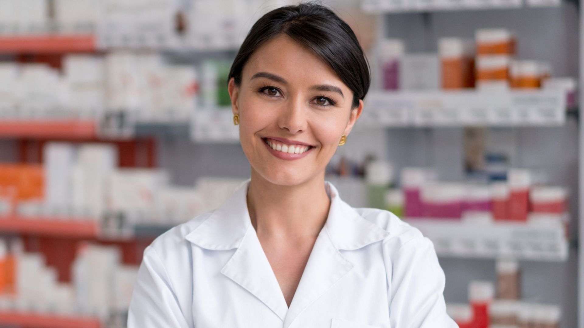pharmacist working at the drugstore and smiling
