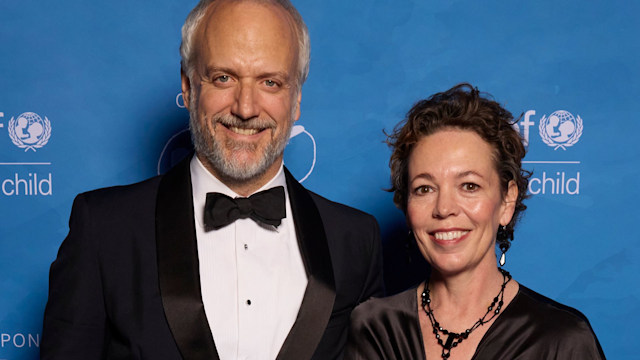 Olivia Coleman in a draped dress with her husband Ed Sinclair in a suit