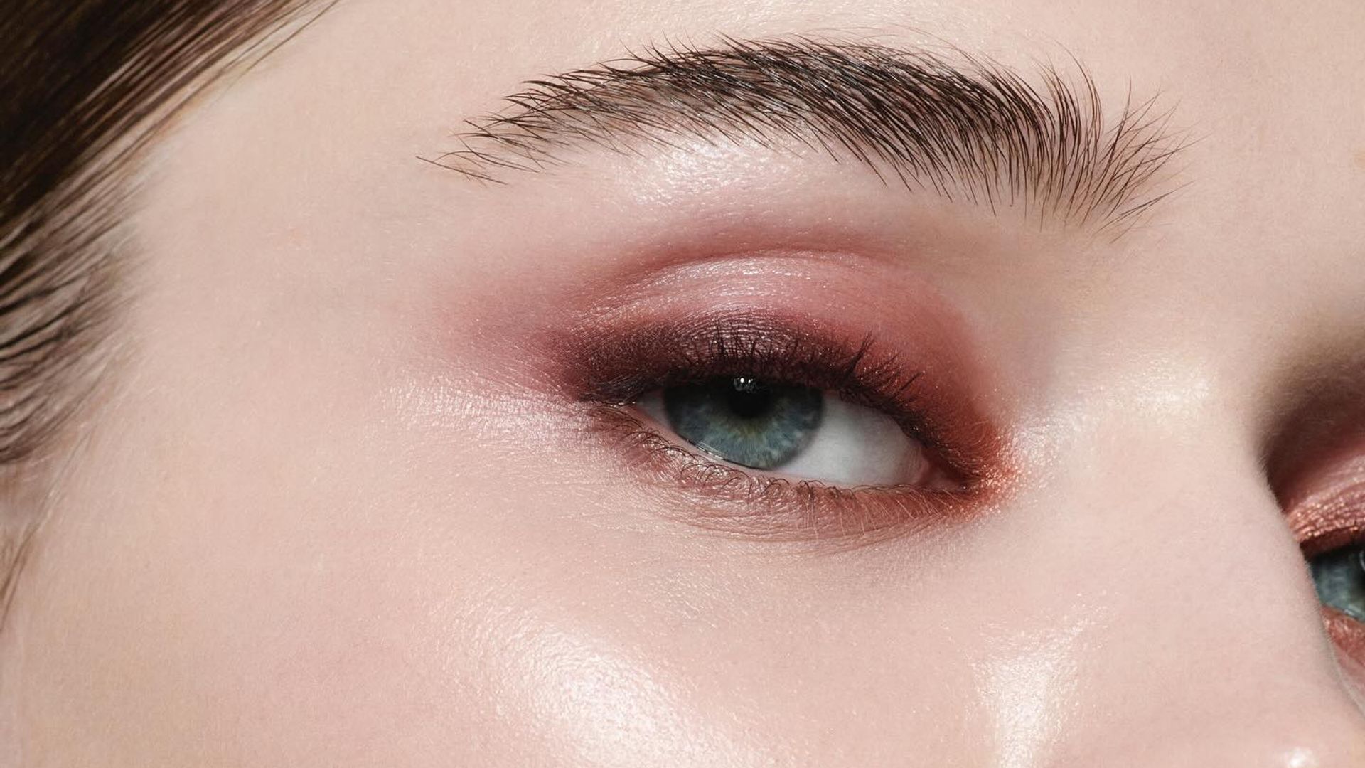 close up a woman with clear skin and burgundy makeup