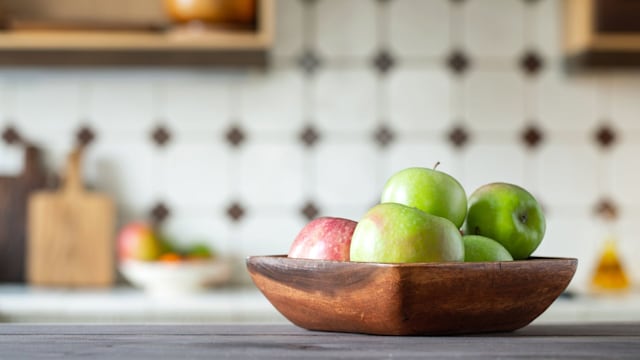 A bowl of apples in a kitchen