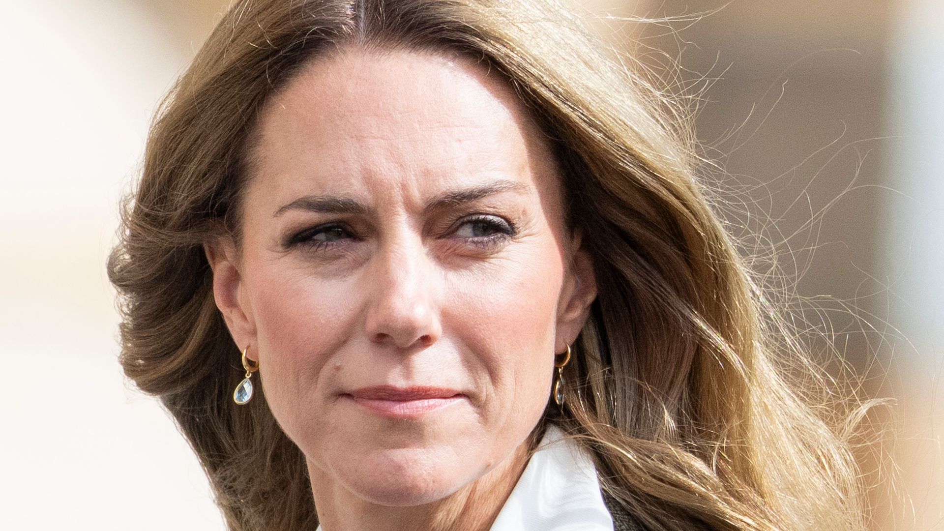 kate in blazer looking over shoulder