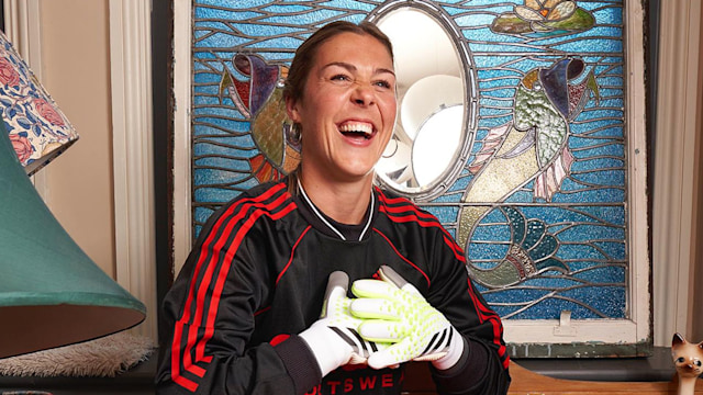 Mary Earps England football goalkeeper smiling as she poses on a chest of drawers