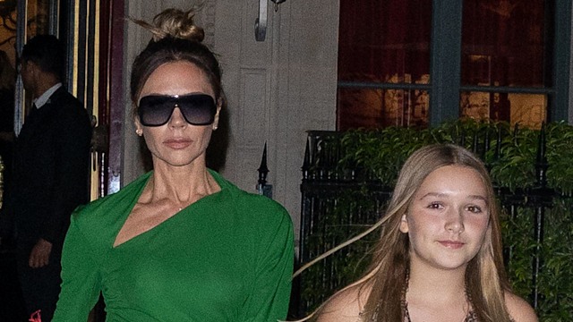 Victoria Beckham in a green dress and Harper Beckham in a yellow dress