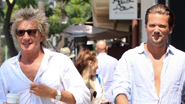 Rod Stewart and Sean Stewart walking along a sunny street