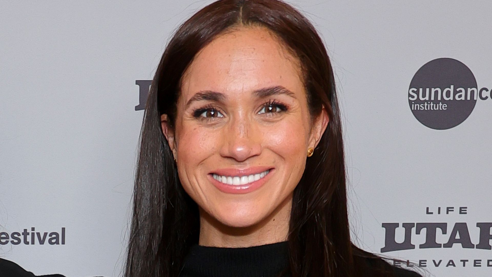 Prince Harry beside Amy Redford and Meghan markle in all black