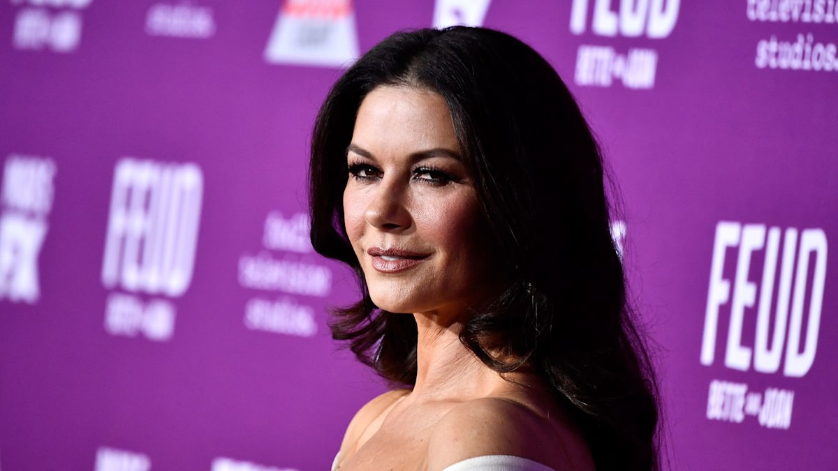 Catherine Zeta-Jones dons deeply plunging swimsuit in killer new photos