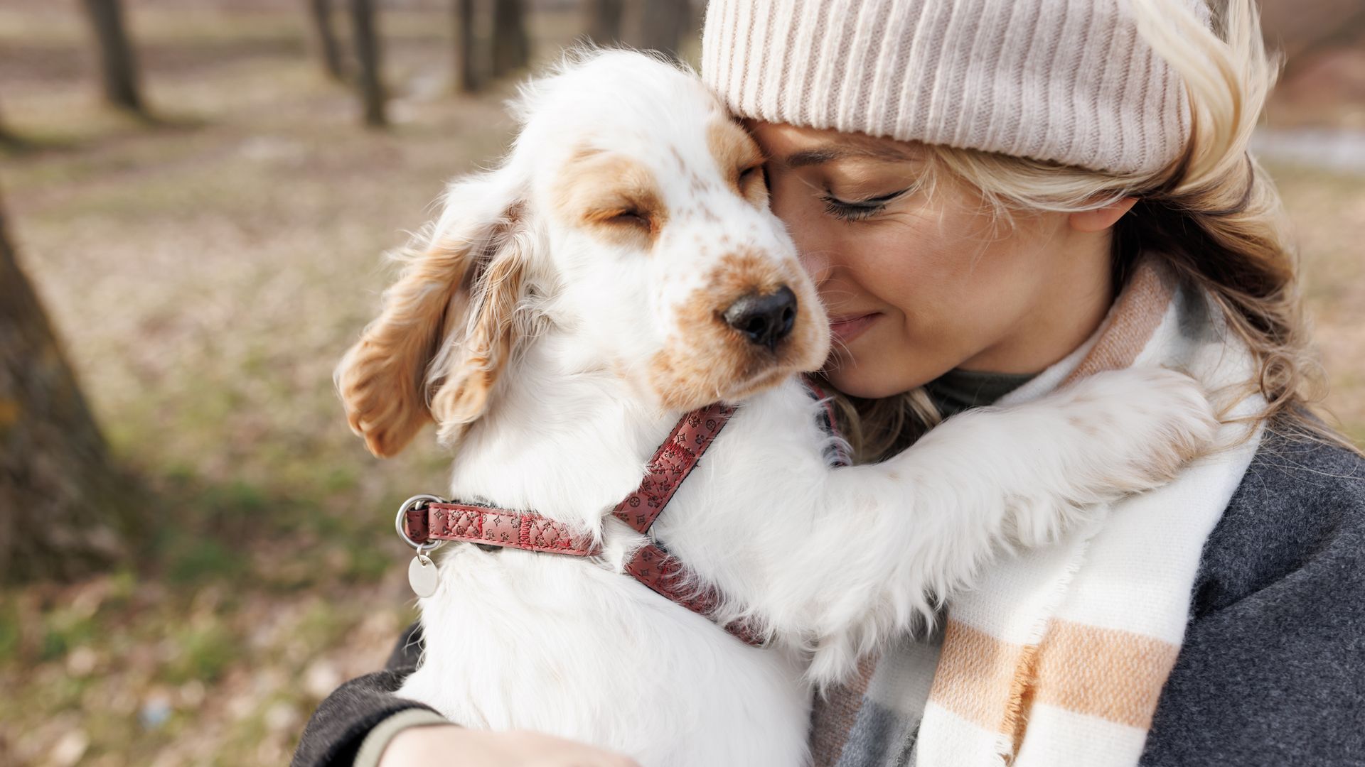 woman cuddling her dog